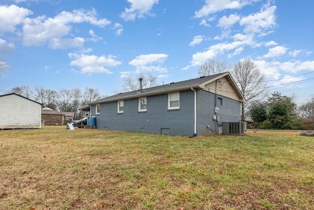 rear view of house featuring a yard and cooling unit