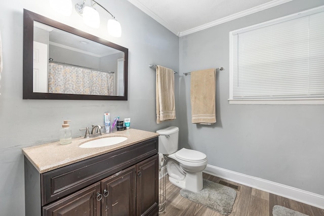 bathroom with vanity, hardwood / wood-style flooring, ornamental molding, and toilet