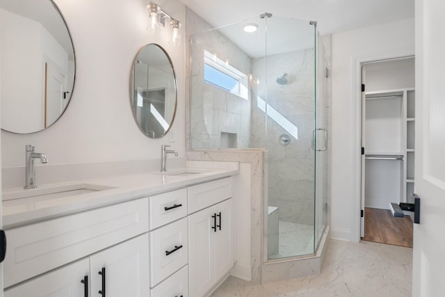 bathroom featuring vanity and an enclosed shower