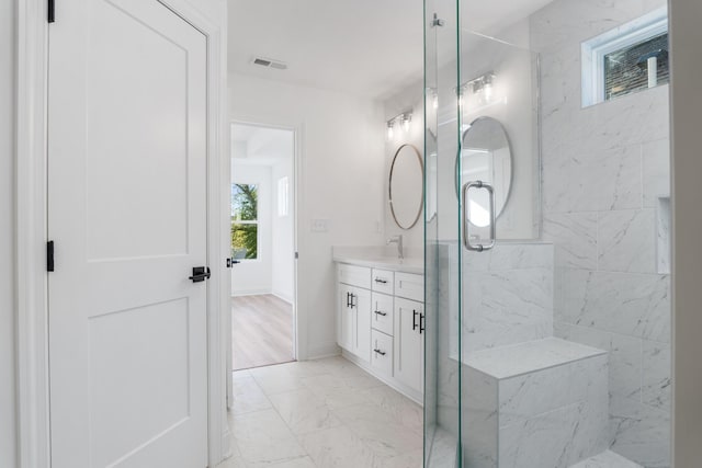 bathroom with vanity and a shower with shower door