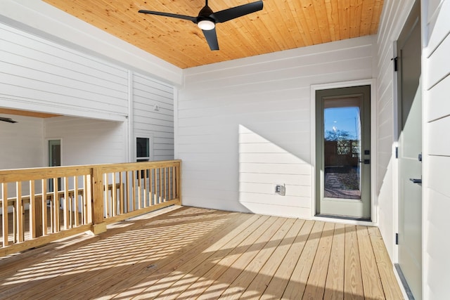 wooden deck featuring ceiling fan