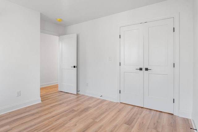 unfurnished bedroom with light hardwood / wood-style floors and a closet