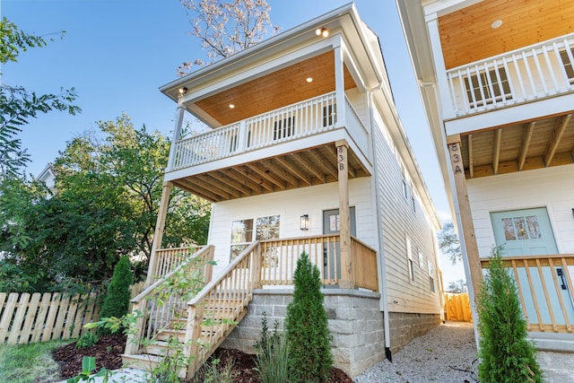 back of house featuring a balcony