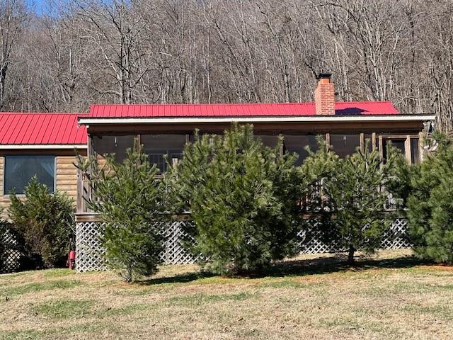 view of side of home featuring a yard