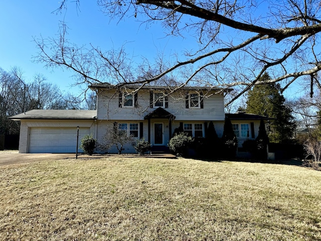 view of property featuring a garage and a front yard