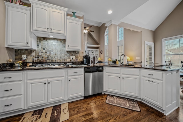 kitchen with stainless steel appliances, kitchen peninsula, sink, and white cabinets