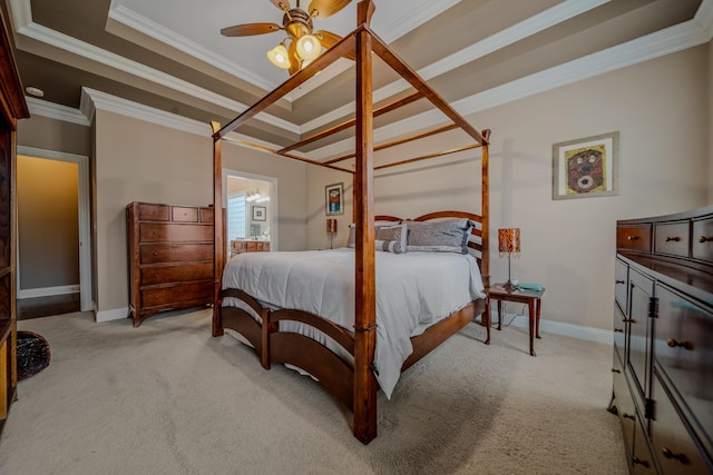 bedroom featuring crown molding, a tray ceiling, light colored carpet, and ceiling fan