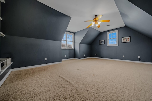 additional living space with vaulted ceiling, carpet flooring, and ceiling fan