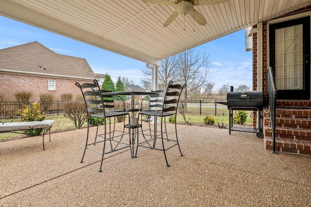 view of patio / terrace with ceiling fan and a grill