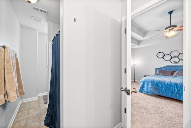 tiled bedroom with ceiling fan