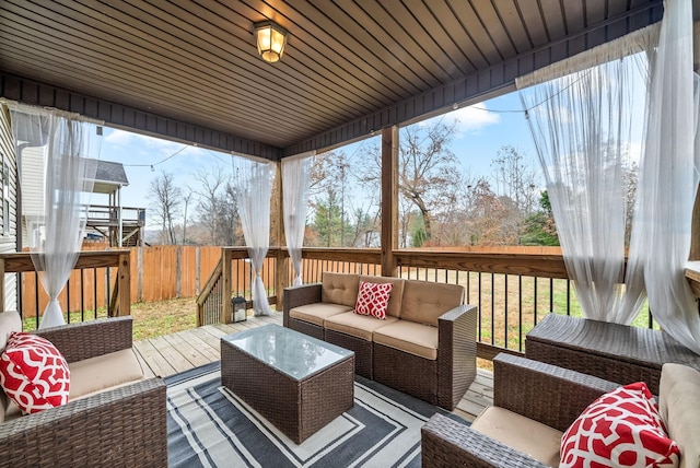 wooden terrace with an outdoor hangout area