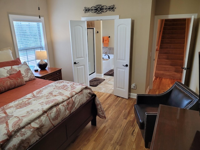 bedroom with light wood-type flooring and baseboards