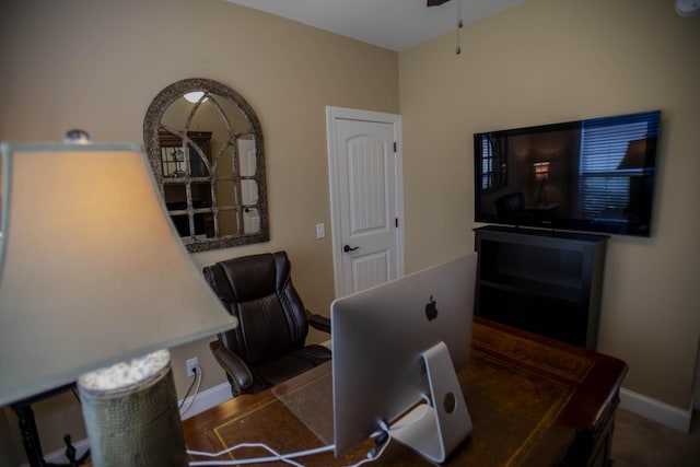 office area featuring a ceiling fan and baseboards