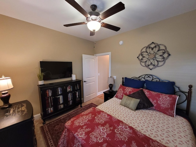 bedroom with ceiling fan and baseboards