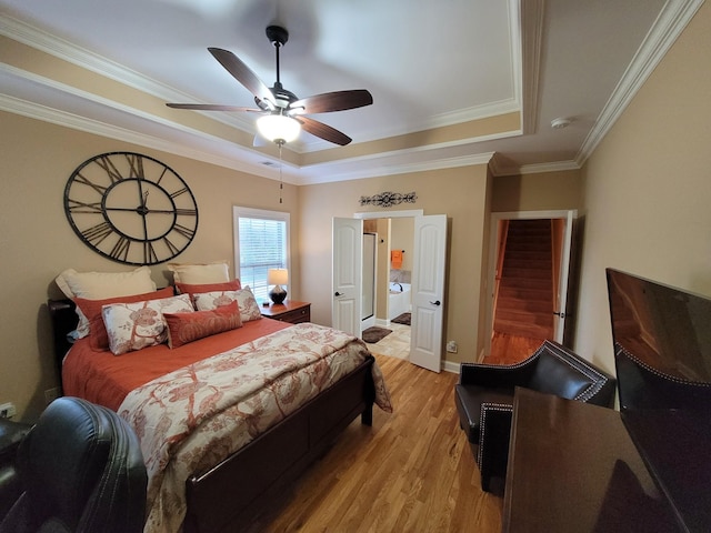 bedroom with ornamental molding, a raised ceiling, ceiling fan, and light wood-type flooring