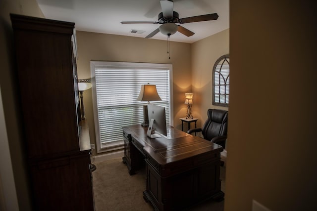 carpeted home office featuring ceiling fan and visible vents