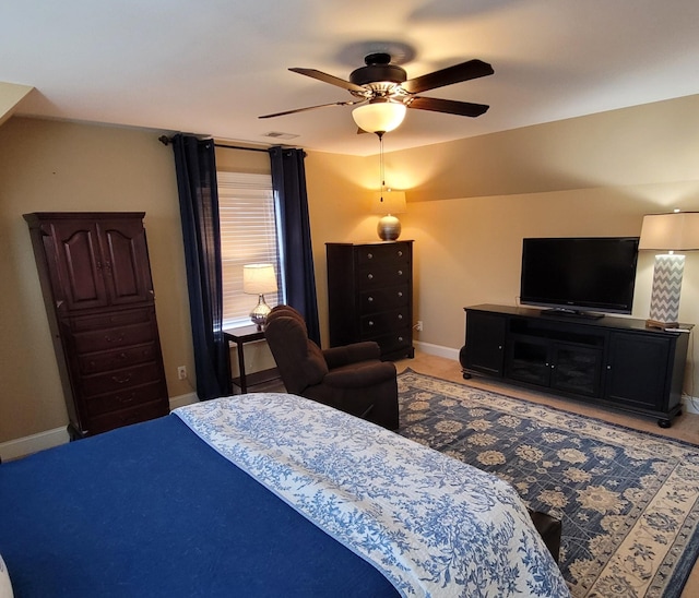 bedroom featuring a ceiling fan, visible vents, and baseboards