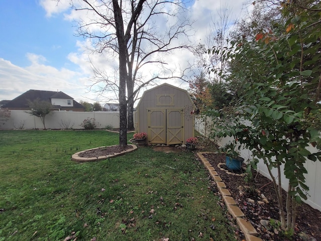 view of yard featuring a shed, fence, and an outbuilding