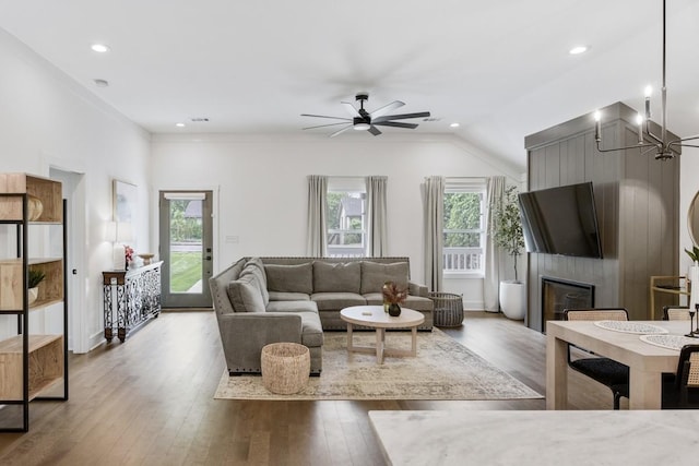 living room with ceiling fan, a large fireplace, a healthy amount of sunlight, and light hardwood / wood-style flooring