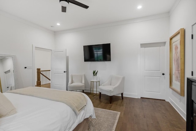 bedroom featuring ornamental molding, dark wood-type flooring, and ceiling fan