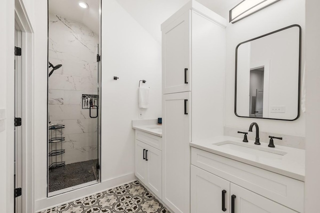 bathroom featuring vanity and a shower with shower door