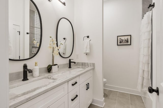 bathroom featuring vanity, tile patterned floors, and toilet