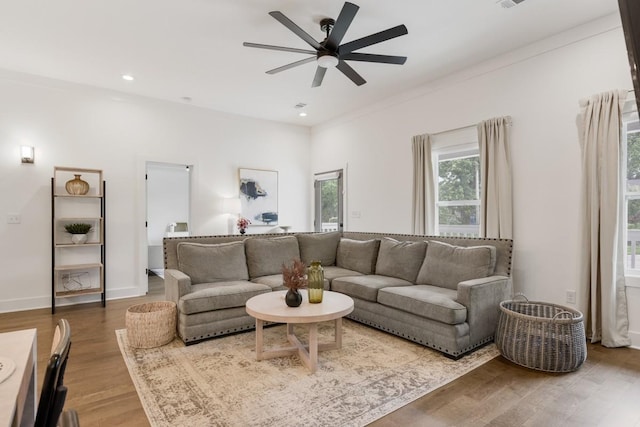 living room featuring hardwood / wood-style flooring and ceiling fan