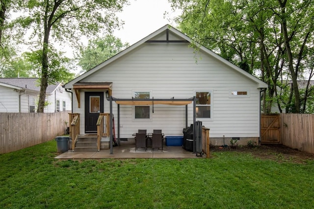 rear view of property featuring a yard and a patio