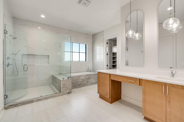 bathroom featuring vanity and separate shower and tub