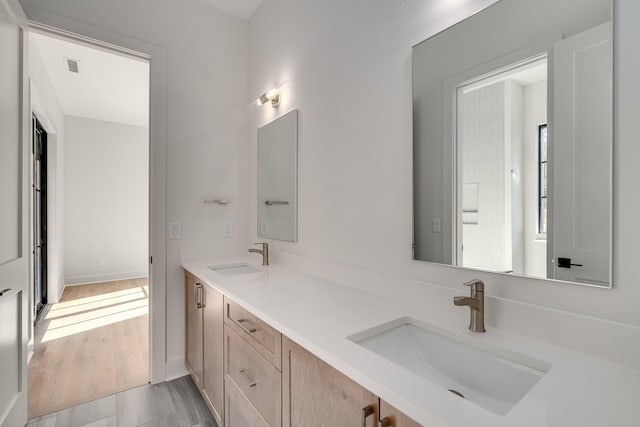 bathroom featuring hardwood / wood-style flooring and vanity