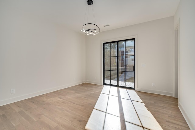 empty room with light hardwood / wood-style flooring