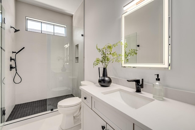 bathroom with walk in shower, vanity, and toilet