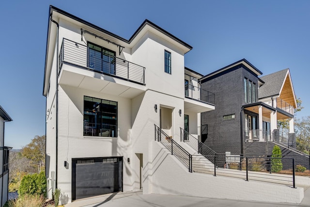 modern home with a balcony and a garage