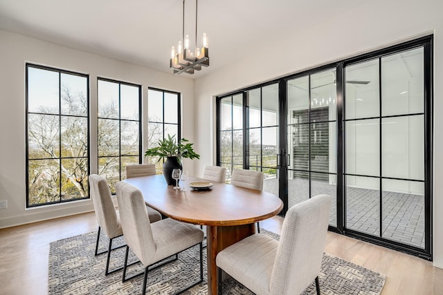 dining area featuring a notable chandelier and light hardwood / wood-style floors