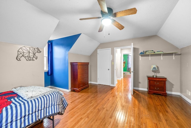 bedroom with lofted ceiling, wood-type flooring, and ceiling fan