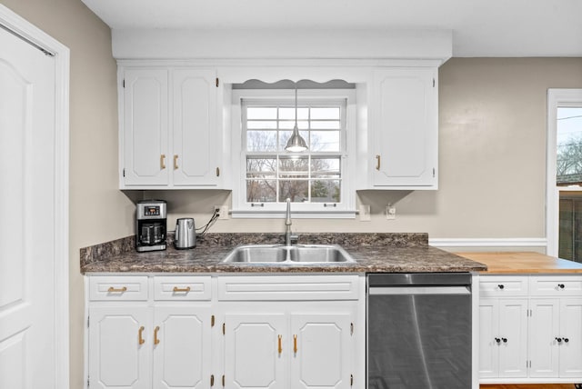 kitchen featuring white cabinetry, pendant lighting, sink, and stainless steel dishwasher