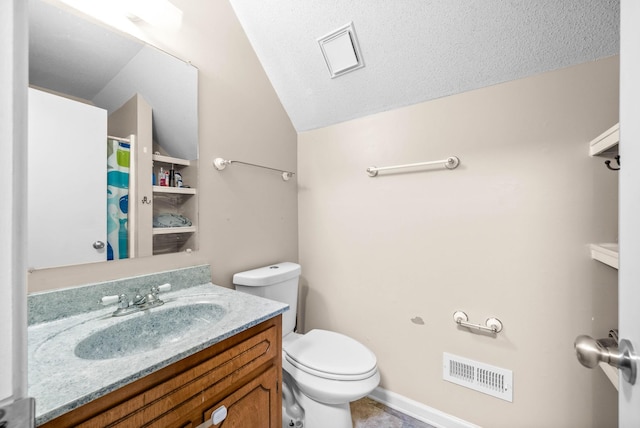 bathroom with vanity, a textured ceiling, vaulted ceiling, and toilet