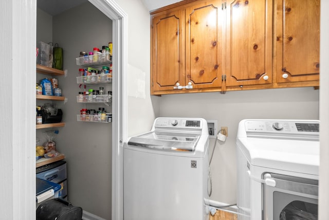 laundry area featuring cabinets and washing machine and dryer