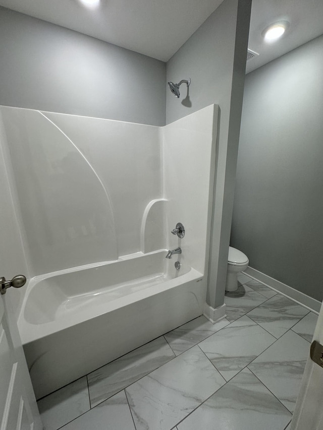 bathroom featuring washtub / shower combination and toilet