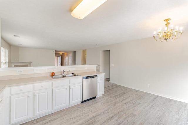 kitchen with pendant lighting, sink, dishwasher, white cabinets, and light wood-type flooring