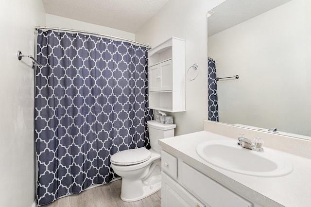 bathroom with vanity, hardwood / wood-style floors, a textured ceiling, and toilet