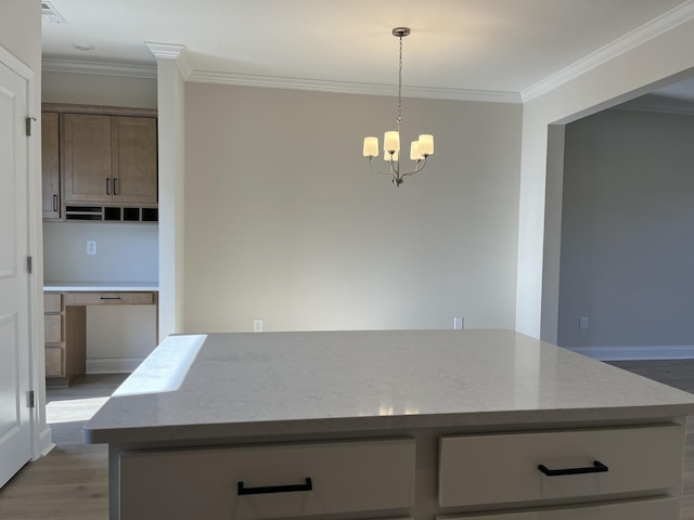 kitchen with ornamental molding, light stone countertops, a center island, and light wood-type flooring