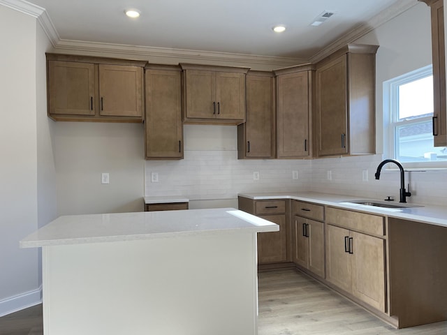 kitchen with a center island, sink, and light hardwood / wood-style flooring