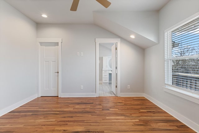 bonus room with hardwood / wood-style floors and ceiling fan