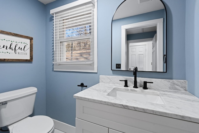 bathroom with vanity and toilet