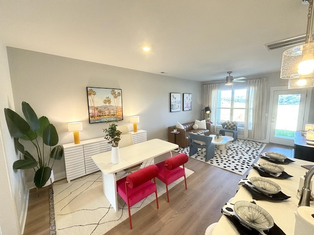 dining space with ceiling fan and hardwood / wood-style floors