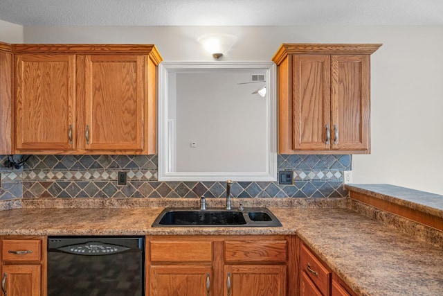 kitchen featuring black dishwasher, decorative backsplash, brown cabinets, a textured ceiling, and a sink