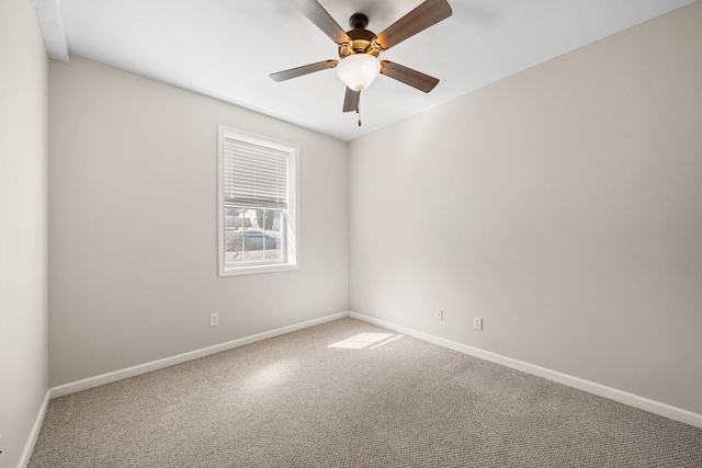 unfurnished room with carpet, a ceiling fan, and baseboards