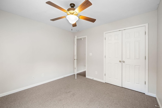 unfurnished bedroom with carpet, baseboards, ceiling fan, and a closet