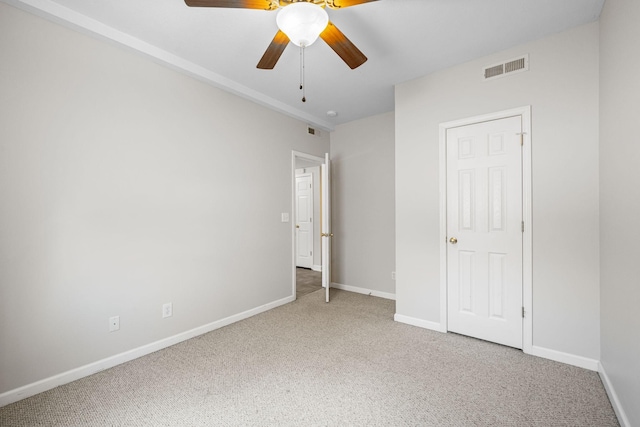 unfurnished bedroom with a ceiling fan, carpet flooring, visible vents, and baseboards